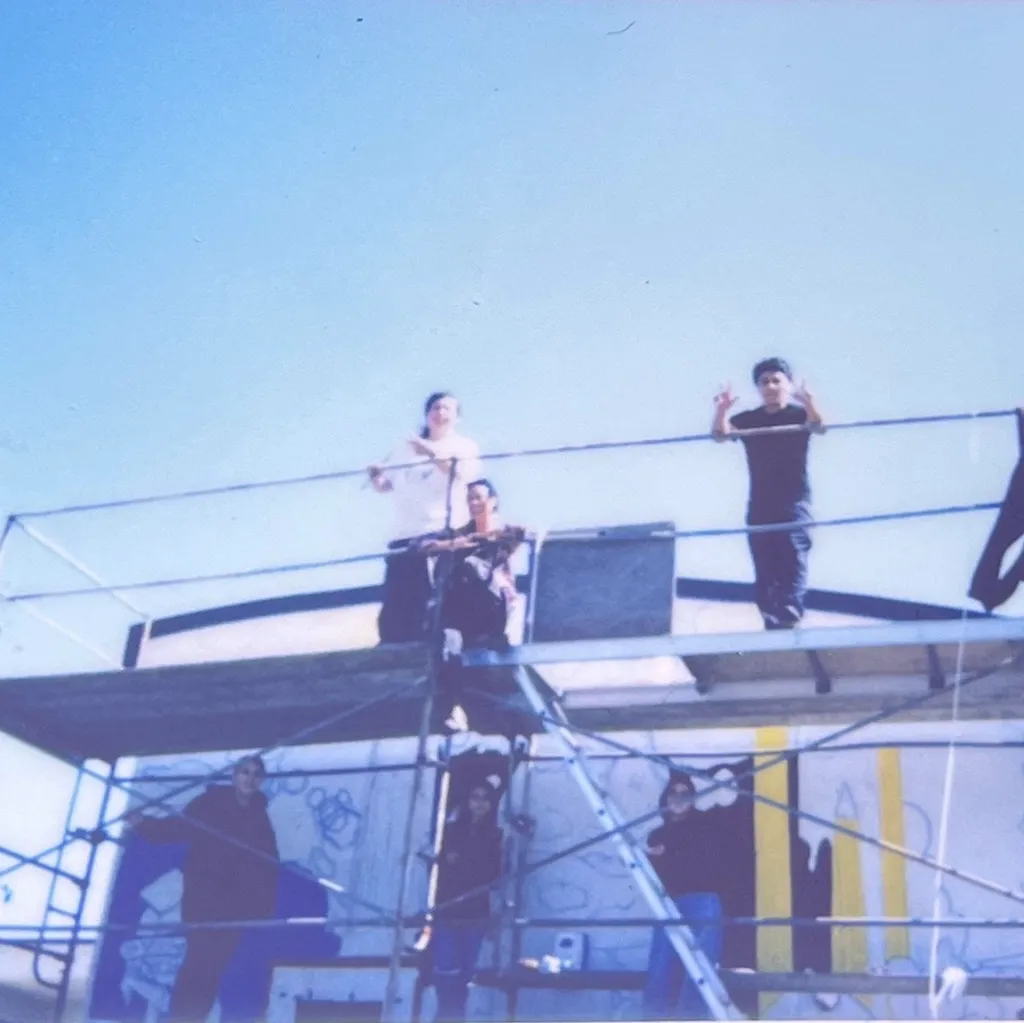 A group of people working on scaffolding in front of a building under construction.